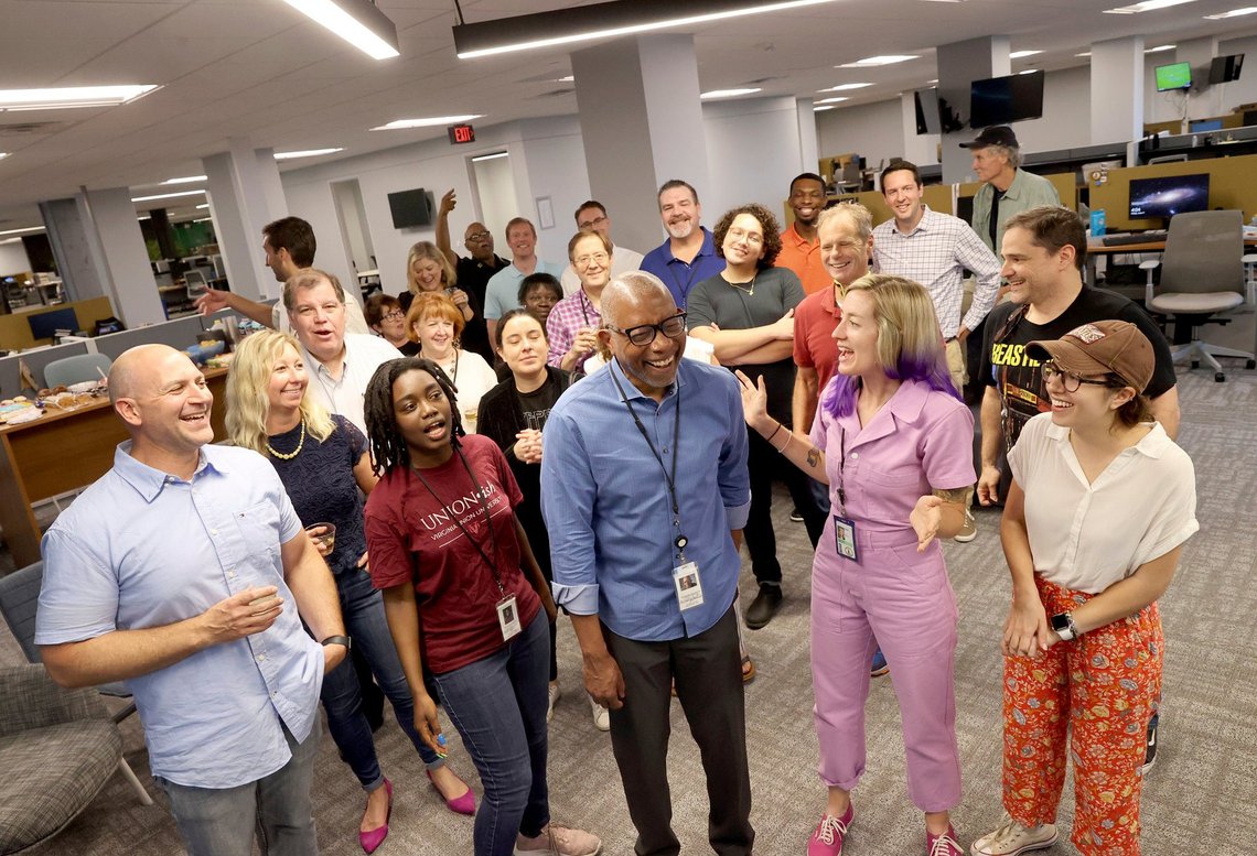 Michael Paul Williams, center, a columnist for the Richmond Times-Dispatch, celebrates with other newsroom staff at the newspaper Friday, June 11, 2021 in Richmond, Va. The Pulitzer Prize for commentary went to Michael Paul Williams of the Richmond Times-Dispatch in Virginia for a series of columns on dismantling Confederate monuments in Richmond following Floyd’s death. (Daniel Sangjib Min/Richmond Times-Dispatch via AP) Michael Paul Williams, center, a columnist for the Richmond Times-Dispatch, celebrates with other newsroom staff at the newspaper Friday, June 11, 2021 in Richmond, Va. The Pulitzer Prize for commentary went to Michael Paul Williams of the Richmond Times-Dispatch in Virginia for a series of columns on dismantling Confederate monuments in Richmond following Floyd’s death. (Daniel Sangjib Min/Richmond Times-Dispatch via AP)