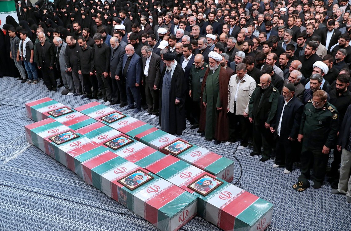 In this photo released by an official website of the office of the Iranian supreme leader, Supreme Leader Ayatollah Ali Khamenei, center with black turban, leads a prayer over the flag-draped coffins of the Revolutionary Guards members who were killed in an airstrike in Syria on Monday widely blamed on Israel, in Tehran, Iran, Thursday, April 4, 2024. (Office of the Iranian Supreme Leader via AP) In this photo released by an official website of the office of the Iranian supreme leader, Supreme Leader Ayatollah Ali Khamenei, center with black turban, leads a prayer over the flag-draped coffins of the Revolutionary Guards members who were killed in an airstrike in Syria on Monday widely blamed on Israel, in Tehran, Iran, Thursday, April 4, 2024. (Office of the Iranian Supreme Leader via AP)