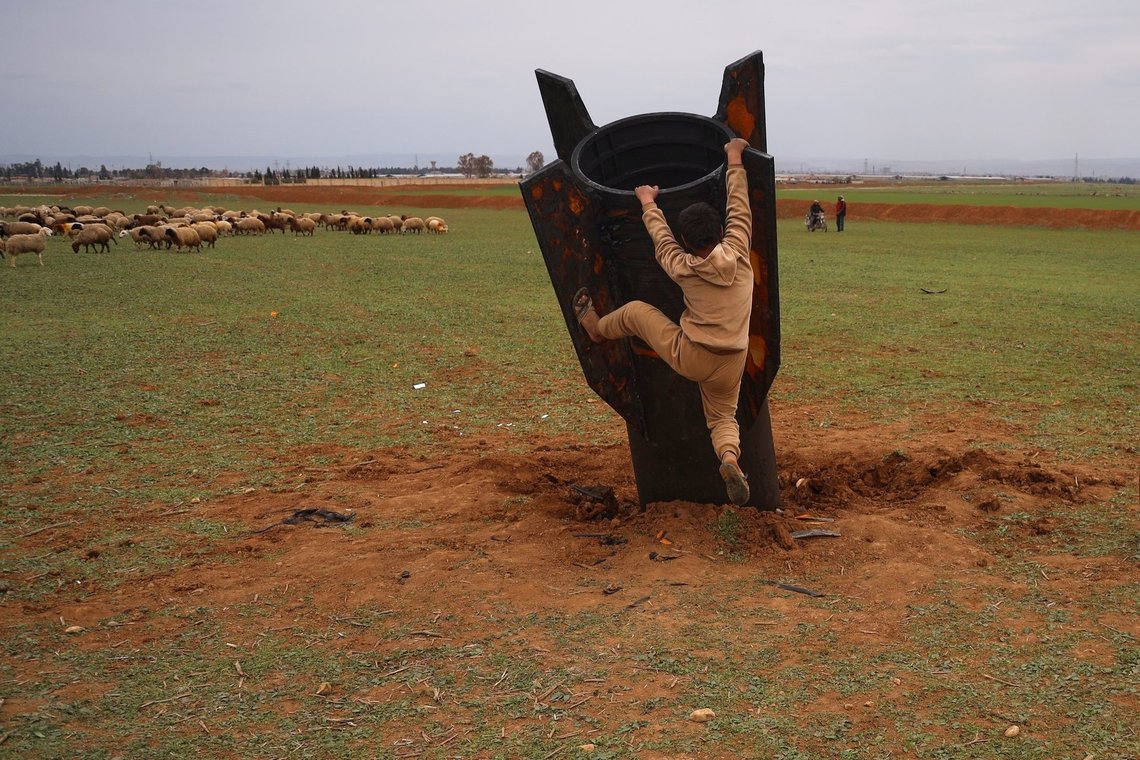 Exposing himself to the danger of unexploded ordnance, a boy tries to climb on an unexploded Iranian projectile that landed in an open field in the outskirts of Qamishli, eastern Syria, Wednesday, March 4, 2026. (AP Photo/Baderkhan Ahmad) Exposing himself to the danger of unexploded ordnance, a boy tries to climb on an unexploded Iranian projectile that landed in an open field in the outskirts of Qamishli, eastern Syria, Wednesday, March 4, 2026. (AP Photo/Baderkhan Ahmad)