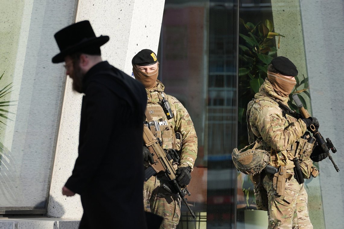 A Jewish man walks past Belgian army soldiers, while they patrol outside a school as part of a security deployment of soldiers outside Jewish institutions in Antwerp, Belgium, Wednesday, March 25, 2026. (AP Photo/Virginia Mayo) A Jewish man walks past Belgian army soldiers, while they patrol outside a school as part of a security deployment of soldiers outside Jewish institutions in Antwerp, Belgium, Wednesday, March 25, 2026. (AP Photo/Virginia Mayo)