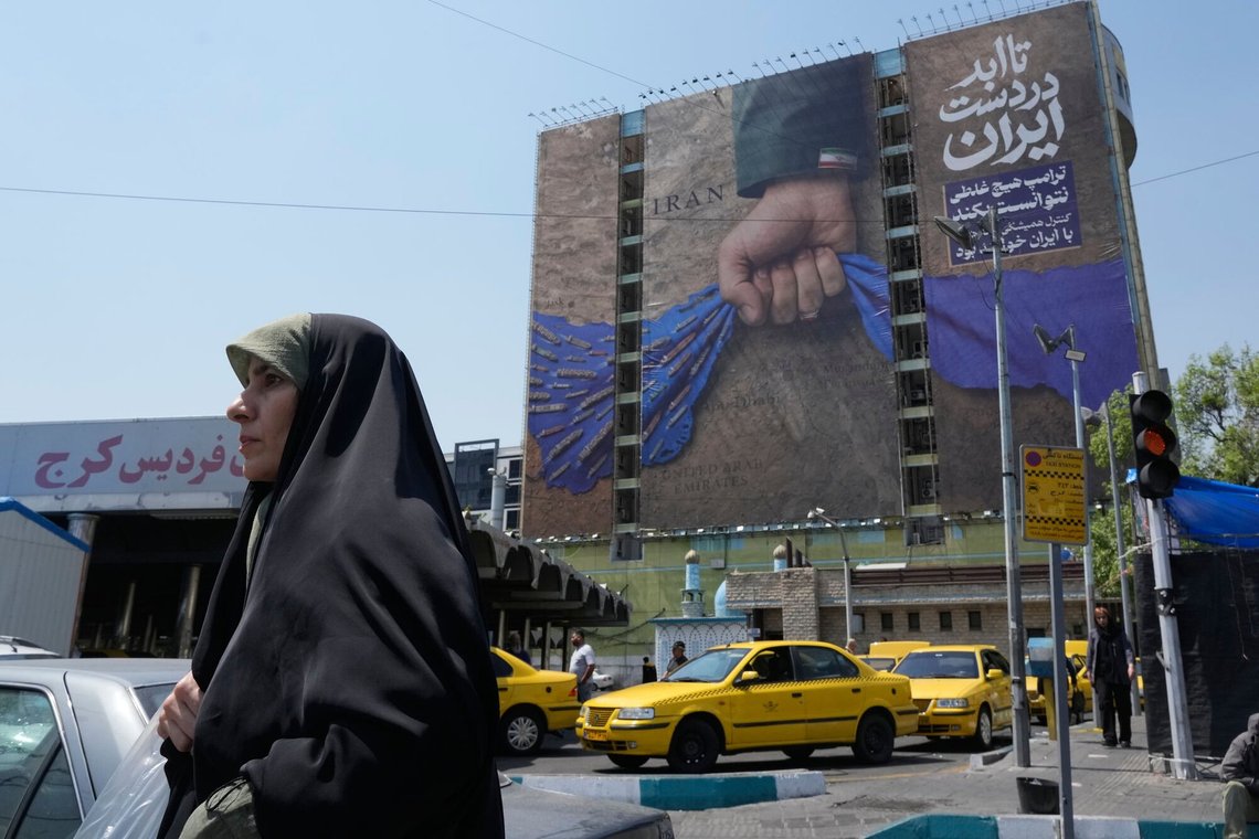 A woman walks past a billboard that shows a graphic depicting a military personnel's hand holding the Strait of Hormuz in his fist with signs which read in Farsi: "In Iran's hands forever," "Trump couldn't do a damn thing," " The control of Strait of Hormuz will be Iran's forever," in Vanak Square, in northern Tehran, Iran, Thursday, April 16, 2026. (AP Photo/Vahid Salemi) A woman walks past a billboard that shows a graphic depicting a military personnel's hand holding the Strait of Hormuz in his fist with signs which read in Farsi: "In Iran's hands forever," "Trump couldn't do a damn thing," " The control of Strait of Hormuz will be Iran's forever," in Vanak Square, in northern Tehran, Iran, Thursday, April 16, 2026. (AP Photo/Vahid Salemi)