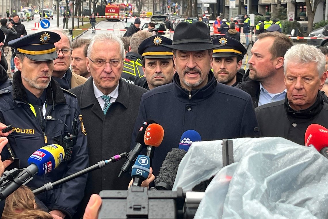 Bavaria's Minister President Markus Söder, with Interior Minister Joachim Herrmann, second left, and Dieter Reiter, right, speaks at the scene of an accident after a driver hit a group of people in Munich, Germany, Thursday Feb. 13, 2025. (Christoph Trost/dpa via AP) Bavaria's Minister President Markus Söder, with Interior Minister Joachim Herrmann, second left, and Dieter Reiter, right, speaks at the scene of an accident after a driver hit a group of people in Munich, Germany, Thursday Feb. 13, 2025. (Christoph Trost/dpa via AP)
