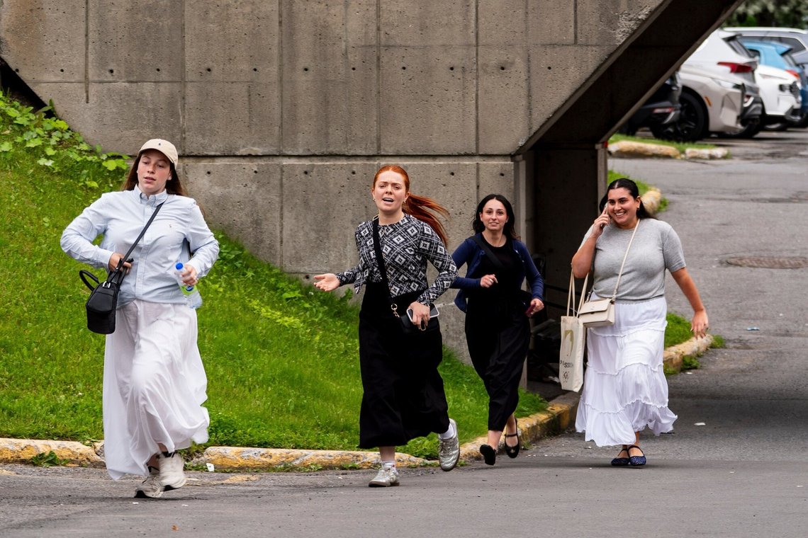 People run out of a shopping center near the scene of a shooting in Montreal on Monday, June 22, 2026. (Christopher Katsarov/The Canadian Press via AP) People run out of a shopping center near the scene of a shooting in Montreal on Monday, June 22, 2026. (Christopher Katsarov/The Canadian Press via AP)