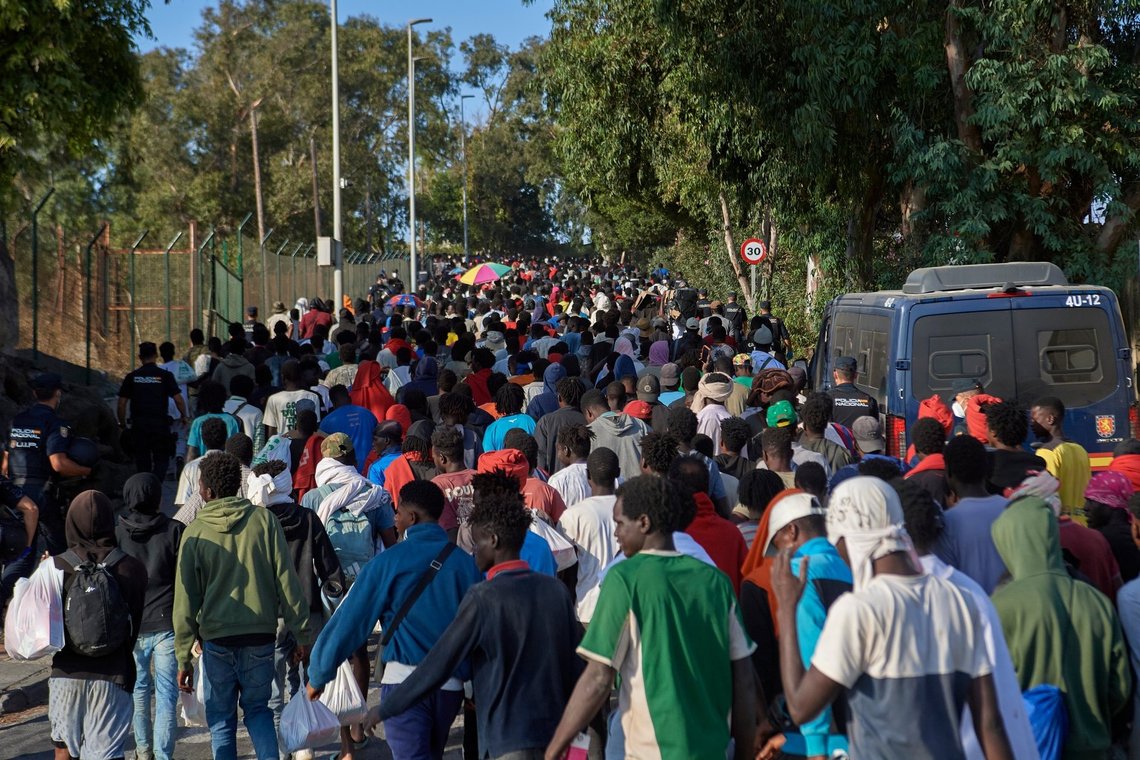 Migrants who crossed from Morocco into Spain are escorted by Spanish police to temporary shelters after being cleared from a beach in the Spanish exlave of Ceuta on Thursday, Aug. 20, 2026. (AP Photo/Antonio Sempere) Migrants who crossed from Morocco into Spain are escorted by Spanish police to temporary shelters after being cleared from a beach in the Spanish exlave of Ceuta on Thursday, Aug. 20, 2026. (AP Photo/Antonio Sempere)