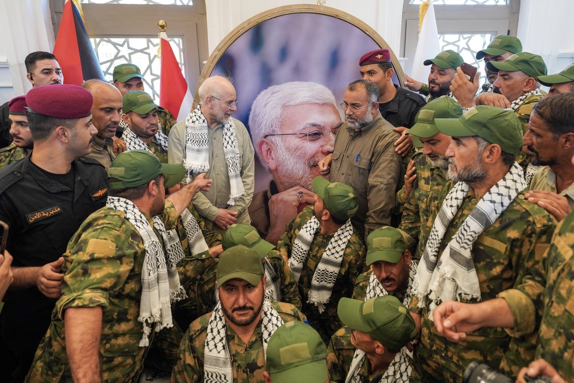 Iran's Parliament Speaker Mohammad Bagher Qalibaf, center left, gathers with members of Iraq's Popular Mobilization Forces during a visit to the grave of Abu Mahdi al-Muhandis, the Iraqi paramilitary commander killed alongside Qassem Soleimani in a 2020 U.S. drone strike, at Wadi al-Salam cemetery in Najaf, Iraq, Friday, Aug. 21, 2026. (AP Photo/Anmar Khalil) Iran's Parliament Speaker Mohammad Bagher Qalibaf, center left, gathers with members of Iraq's Popular Mobilization Forces during a visit to the grave of Abu Mahdi al-Muhandis, the Iraqi paramilitary commander killed alongside Qassem Soleimani in a 2020 U.S. drone strike, at Wadi al-Salam cemetery in Najaf, Iraq, Friday, Aug. 21, 2026. (AP Photo/Anmar Khalil)