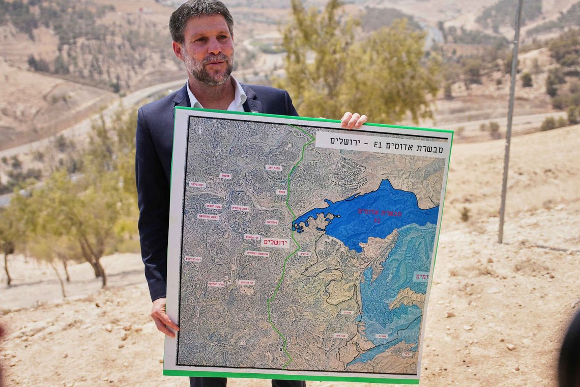 ARKIV - Den israelske finansminister Bezalel Smotrich holder et kort, der viser E1-bosættelsesprojektet, under en pressekonference nær bosættelsen Maale Adumim på Vestbreden (Judæa og Samaria), 14. august 2025. (AP Photo/Ohad Zwigenberg, Arkiv) ARKIV - Den israelske finansminister Bezalel Smotrich holder et kort, der viser E1-bosættelsesprojektet, under en pressekonference nær bosættelsen Maale Adumim på Vestbreden (Judæa og Samaria), 14. august 2025. (AP Photo/Ohad Zwigenberg, Arkiv)