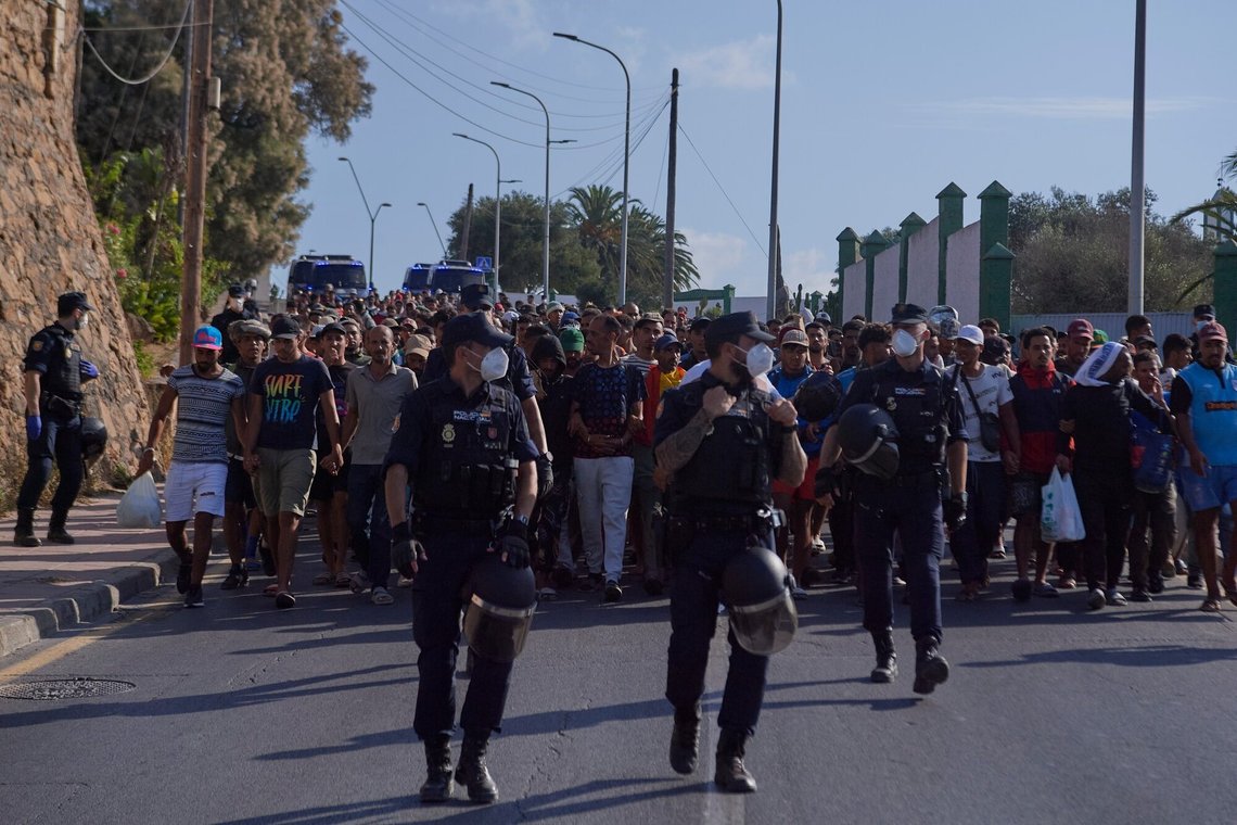 Migrants who crossed from Morocco into Spain are escorted by Spanish police to temporary shelters after being cleared from a beach in the Spanish exclave of Ceuta on Thursday, Aug. 20, 2026. (AP Photo/Antonio Sempere) Migrants who crossed from Morocco into Spain are escorted by Spanish police to temporary shelters after being cleared from a beach in the Spanish exclave of Ceuta on Thursday, Aug. 20, 2026. (AP Photo/Antonio Sempere)
