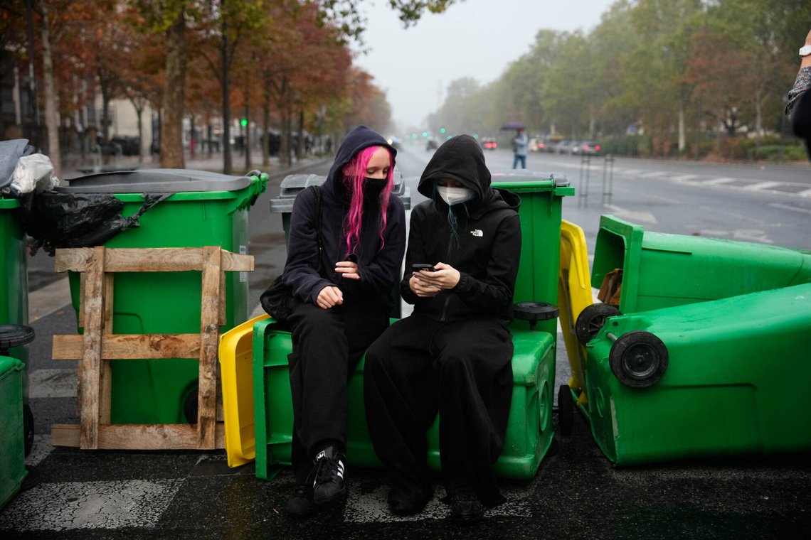 A student checks her smartphone in front of the Helene Boucher high school blockaded with garbage bins during a protest against under-resourced schools in Paris, Tuesday, Oct. 13, 2026. (AP Photo/Teresa Suarez) A student checks her smartphone in front of the Helene Boucher high school blockaded with garbage bins during a protest against under-resourced schools in Paris, Tuesday, Oct. 13, 2026. (AP Photo/Teresa Suarez)