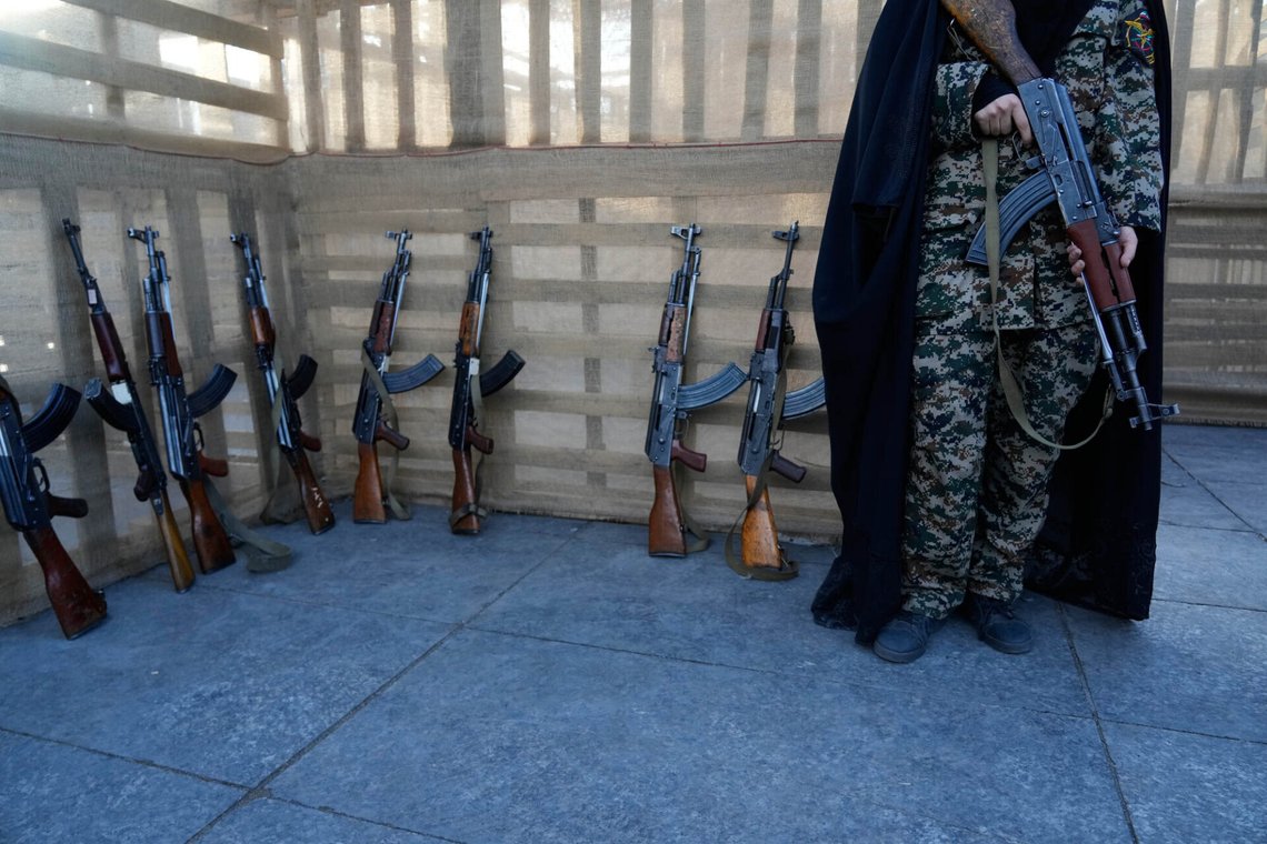 A member of the military affiliated with Iran's Revolutionary Guard, stands next to Kalashnikov-style assault rifles in a military training course at a camp set up in Imam Hussein Square in Tehran, Sunday, Oct. 4, 2026. (AP Photo/Vahid Salemi) A member of the military affiliated with Iran's Revolutionary Guard, stands next to Kalashnikov-style assault rifles in a military training course at a camp set up in Imam Hussein Square in Tehran, Sunday, Oct. 4, 2026. (AP Photo/Vahid Salemi)