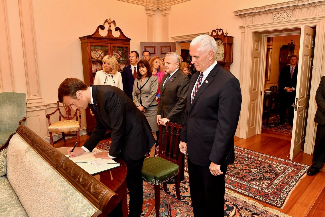 Acting Secretary of State John Sullivan and Vice President Mike Pence look on as French President Emmanuel Macron signs the U.S. Department of State's guestbook before the state luncheon at the U.S. Department of State in Washington, D.C. Photo: U.S. Department of State from United States, Public domain, via Wikimedia Commons Acting Secretary of State John Sullivan and Vice President Mike Pence look on as French President Emmanuel Macron signs the U.S. Department of State's guestbook before the state luncheon at the U.S. Department of State in Washington, D.C. Photo: U.S. Department of State from United States, Public domain, via Wikimedia Commons