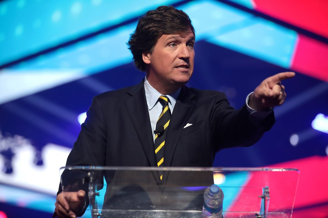 File - Tucker Carlson speaking with attendees at the 2021 AmericaFest at the Phoenix Convention Center in Phoenix, Arizona. A racist text message from Tucker Carlson is what helped drive the commentator's ouster from Fox News, The New York Times reports. The Times says that in a text uncovered as part of a recent defamation lawsuit, the former Fox host lamented how supporters of former President Donald Trump ganged up to beat a protester. "It's not how white men fight," Carlson wrote. (Photo: Gage Skidmore from Surprise, AZ, United States of America, CC BY-SA 2.0, Wikimedia Commons) File - Tucker Carlson speaking with attendees at the 2021 AmericaFest at the Phoenix Convention Center in Phoenix, Arizona. A racist text message from Tucker Carlson is what helped drive the commentator's ouster from Fox News, The New York Times reports. The Times says that in a text uncovered as part of a recent defamation lawsuit, the former Fox host lamented how supporters of former President Donald Trump ganged up to beat a protester. "It's not how white men fight," Carlson wrote. (Photo: Gage Skidmore from Surprise, AZ, United States of America, CC BY-SA 2.0, Wikimedia Commons)