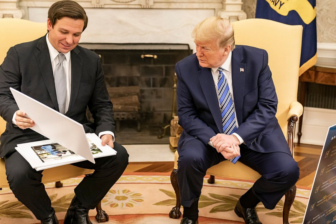 FILE - President Donald J. Trump looks at diagrams and photos during his meeting with Florida Gov. Ron DeSantis Tuesday, April 28, 2020, in the Oval Office of the White House. (Official Photo by Shealah Craighead). Before Trump and DeSantis were leading rivals for the 2024 Republican presidential nomination, they were allies. (The White House from Washington, DC, Public domain, via Wikimedia Commons) FILE - President Donald J. Trump looks at diagrams and photos during his meeting with Florida Gov. Ron DeSantis Tuesday, April 28, 2020, in the Oval Office of the White House. (Official Photo by Shealah Craighead). Before Trump and DeSantis were leading rivals for the 2024 Republican presidential nomination, they were allies. (The White House from Washington, DC, Public domain, via Wikimedia Commons)