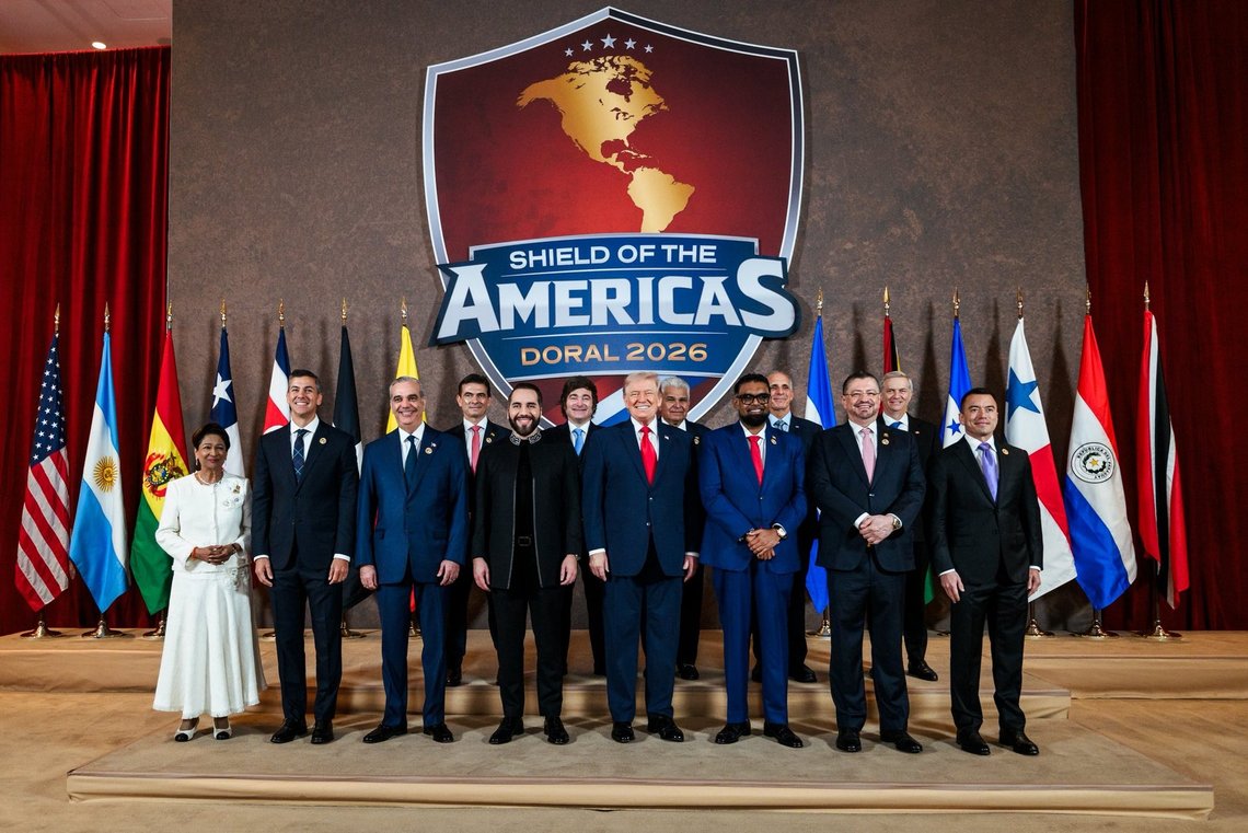 Summit of the Shields of Americas, 2026. Group photo from the Shield of the Americas Summit, Saturday, March 7, 2026, at Trump National Doral Miami in Florida.
Front row, from left: Prime Minister of Trinidad and Tobago Kamla Persad-Bissessar, President of Paraguay Santiago Peña, President of the Dominican Republic Luis Abinader, President of El Salvador Nayib Bukele, President Donald Trump, President of Guyana Mohamed Irfaan Ali, President of Costa Rica Rodrigo Chaves Robles, and President of Ecuador Daniel Noboa.
Back row, from left: President of Bolivia Rodrigo Paz Pereira, President of Argentina Javier Milei, President of Panama José Raúl Mulino, President of Honduras Nasry Asfura (not visible), and Chile’s president-elect José Antonio Kast (partially visible).(By Daniel Torok - https://x.com/WhiteHouse/status/2030300999190040852/photo/1, Public Domain, https://commons.wikimedia.org/w/index.php?curid=185665734) Summit of the Shields of Americas, 2026. Group photo from the Shield of the Americas Summit, Saturday, March 7, 2026, at Trump National Doral Miami in Florida.
Front row, from left: Prime Minister of Trinidad and Tobago Kamla Persad-Bissessar, President of Paraguay Santiago Peña, President of the Dominican Republic Luis Abinader, President of El Salvador Nayib Bukele, President Donald Trump, President of Guyana Mohamed Irfaan Ali, President of Costa Rica Rodrigo Chaves Robles, and President of Ecuador Daniel Noboa.
Back row, from left: President of Bolivia Rodrigo Paz Pereira, President of Argentina Javier Milei, President of Panama José Raúl Mulino, President of Honduras Nasry Asfura (not visible), and Chile’s president-elect José Antonio Kast (partially visible).(By Daniel Torok - https://x.com/WhiteHouse/status/2030300999190040852/photo/1, Public Domain, https://commons.wikimedia.org/w/index.php?curid=185665734)