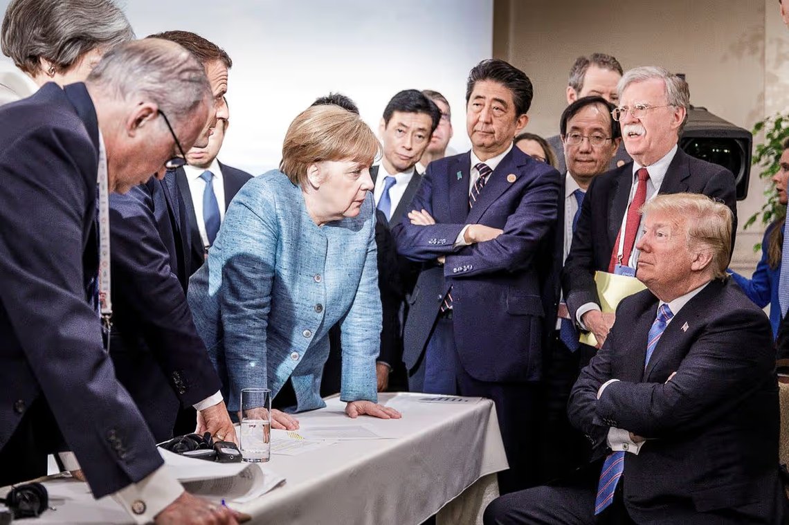 German Chancellor Angela Merkel speaks to U.S. President Donald Trump during a tense exchange at the G7 summit in Charlevoix, Canada, June 2018, in a moment widely seen as symbolising strains between the United States and its European allies. Photo: Jesco Denzel / German Federal Government. Creative Commons Attribution-ShareAlike 3.0 Germany (CC BY-SA 3.0 DE) German Chancellor Angela Merkel speaks to U.S. President Donald Trump during a tense exchange at the G7 summit in Charlevoix, Canada, June 2018, in a moment widely seen as symbolising strains between the United States and its European allies. Photo: Jesco Denzel / German Federal Government. Creative Commons Attribution-ShareAlike 3.0 Germany (CC BY-SA 3.0 DE)