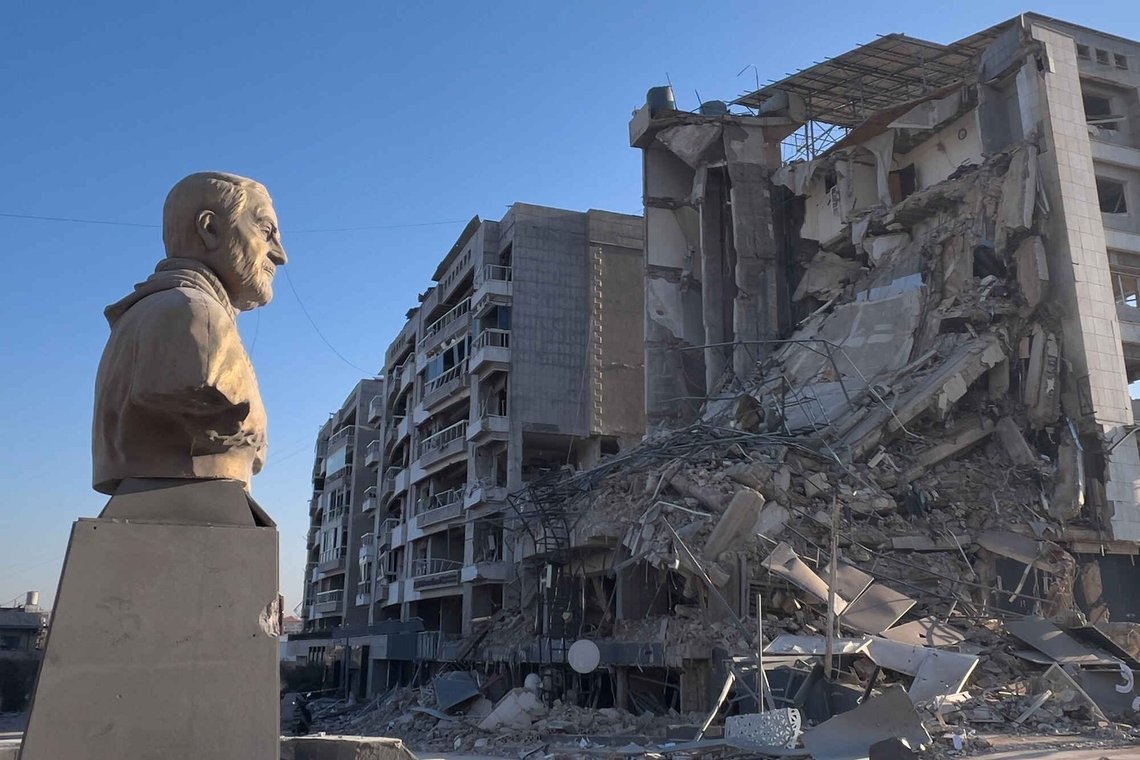 A bust of the late Iranian General Qassem Soleimani stands in front of a destroyed building that housed a branch of Al-Qard Al-Hassan, a non-bank financial institution run by Hezbollah, which was hit by an Israeli airstrike in Dahiyeh, Beirut's southern suburbs, Lebanon, Tuesday, March 10, 2026. A bust of the late Iranian General Qassem Soleimani stands in front of a destroyed building that housed a branch of Al-Qard Al-Hassan, a non-bank financial institution run by Hezbollah, which was hit by an Israeli airstrike in Dahiyeh, Beirut's southern suburbs, Lebanon, Tuesday, March 10, 2026.