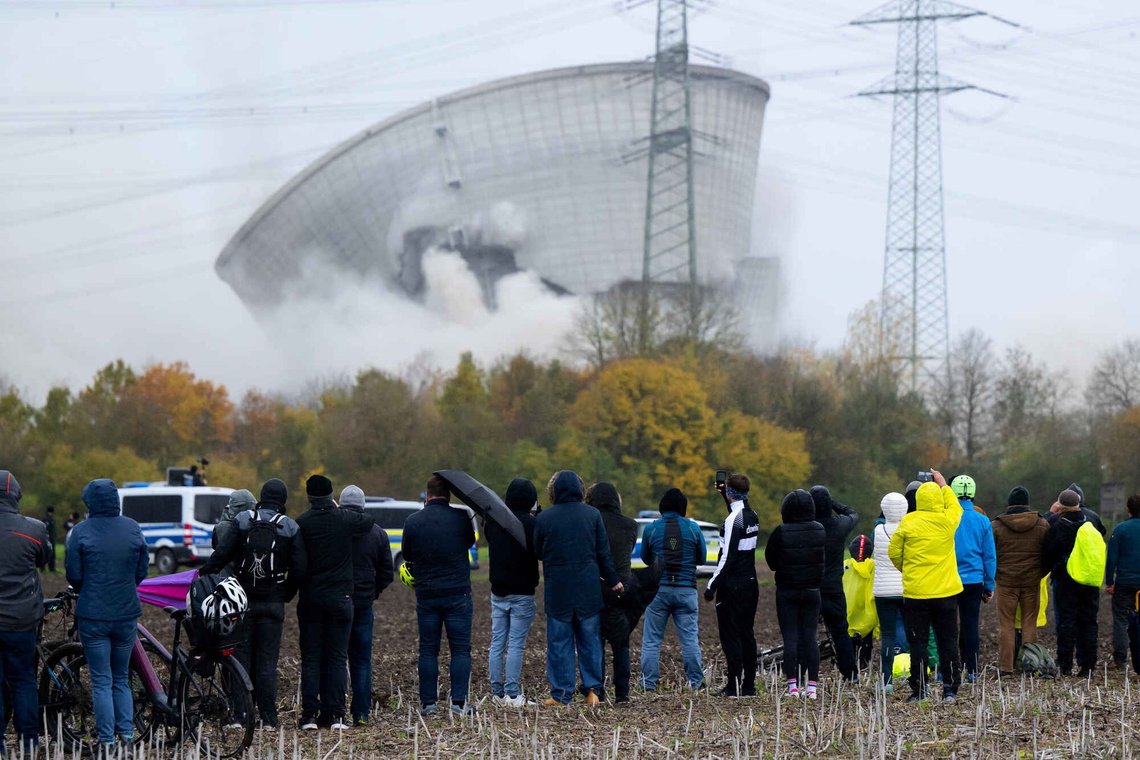People watch as the second cooling tower of the decommissioned Gundremmingen nuclear power plant collapses after blasting, in Gundremmingen, Germany, Saturday, Oct. 25, 2025. (Sven Hoppe/dpa via AP) People watch as the second cooling tower of the decommissioned Gundremmingen nuclear power plant collapses after blasting, in Gundremmingen, Germany, Saturday, Oct. 25, 2025. (Sven Hoppe/dpa via AP)