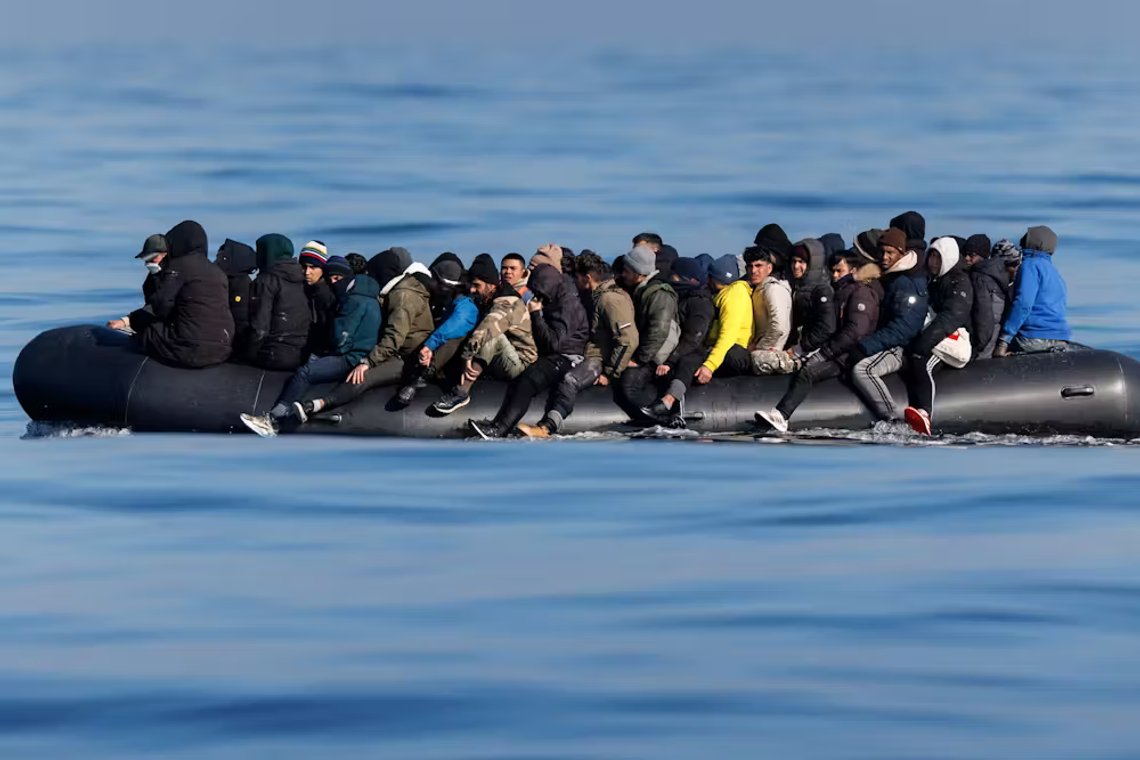 Migrants crossing the English Channel in an overloaded inflatable boat. Migrants crossing the English Channel in an overloaded inflatable boat.