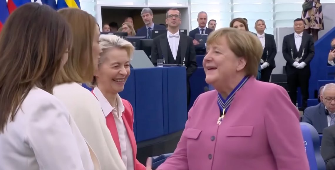 Former German Chancellor Angela Merkel delivers a speech and receives the European Order of Merit during a ceremony at the European Parliament in Strasbourg, eastern France, on 19 May 2026, flanked by Ursula von der Leyen. The award honours individuals who have made outstanding contributions to European unity, democracy, or the promotion and defense of European values. Video still from YouTube. Former German Chancellor Angela Merkel delivers a speech and receives the European Order of Merit during a ceremony at the European Parliament in Strasbourg, eastern France, on 19 May 2026, flanked by Ursula von der Leyen. The award honours individuals who have made outstanding contributions to European unity, democracy, or the promotion and defense of European values. Video still from YouTube.