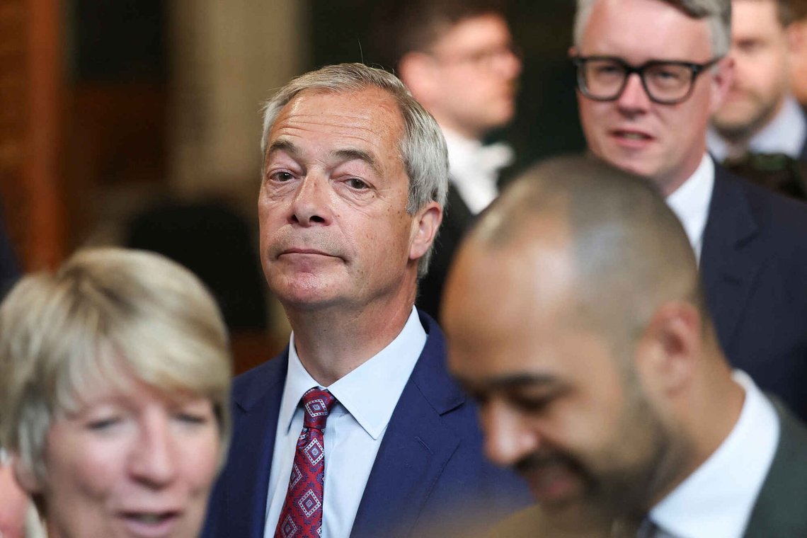 Reform UK Leader Nigel Farage walks through the House of Commons to attend the State Opening of Parliament at the Palace of Westminster, London, Wednesday, May 13, 2026. Reform UK Leader Nigel Farage walks through the House of Commons to attend the State Opening of Parliament at the Palace of Westminster, London, Wednesday, May 13, 2026.