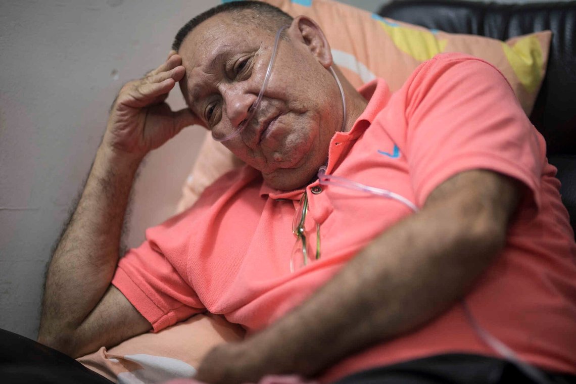 Victor Escobar sits at his home during an interview in Cali, Colombia, Thursday, Jan. 6, 2022. Escobar, who suffers chronic obstructive pulmonary disease, oxygen dependence, lack of muscle control and secondary effects from a stroke is scheduled on the evening of Jan. 7 to become the first person to receive euthanasia legally, without being a terminally ill patient. Euthanasia for terminally ill patients is legal in Colombia. Victor Escobar sits at his home during an interview in Cali, Colombia, Thursday, Jan. 6, 2022. Escobar, who suffers chronic obstructive pulmonary disease, oxygen dependence, lack of muscle control and secondary effects from a stroke is scheduled on the evening of Jan. 7 to become the first person to receive euthanasia legally, without being a terminally ill patient. Euthanasia for terminally ill patients is legal in Colombia.