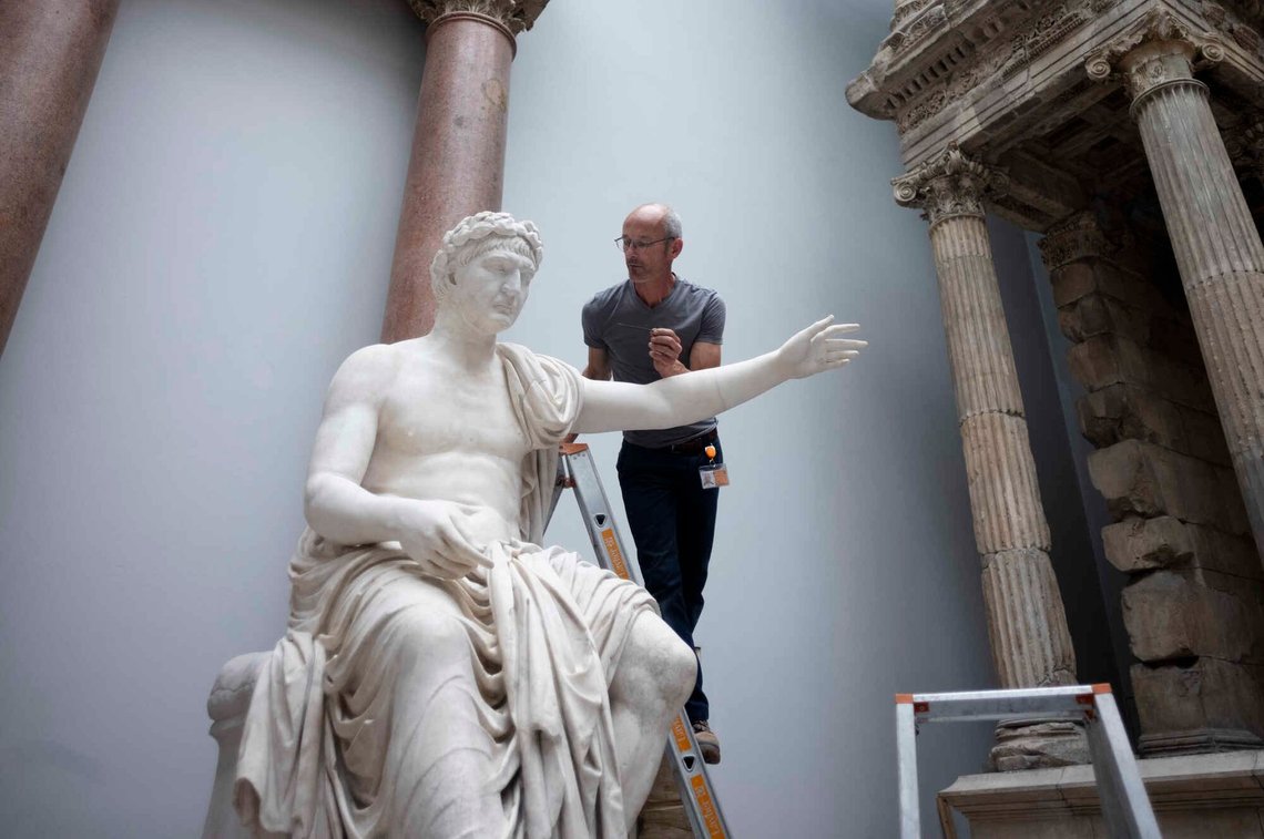 Sculptor and restorer Steffen Werner shows how the "Seated figure of the Roman Emperor Trajan" is being prepaired for transportation to a temporary storage facility during a press event at the Museum of Pergamon Museum in Berlin, Germany, Friday, May 24, 2024. One of Berlin's biggest tourist magnets, the Pergamon Museum, is closed completed due to renovation for four years. The entire renovation works are currently estimated to cost about $1.6 billion and won't be fully completed until 2037. (AP Photo/Markus Schreiber) Sculptor and restorer Steffen Werner shows how the "Seated figure of the Roman Emperor Trajan" is being prepaired for transportation to a temporary storage facility during a press event at the Museum of Pergamon Museum in Berlin, Germany, Friday, May 24, 2024. One of Berlin's biggest tourist magnets, the Pergamon Museum, is closed completed due to renovation for four years. The entire renovation works are currently estimated to cost about $1.6 billion and won't be fully completed until 2037. (AP Photo/Markus Schreiber)