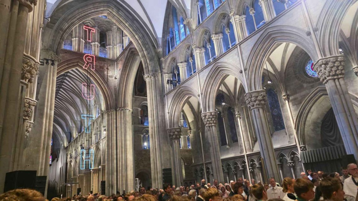 Lars Ø. Ramberg's artwork Truth as it appeared during the Catholic Olsok Mass in Nidaros Cathedral on 29 July 2026: a 17-metre-high neon light installation suspended from the ceiling. Photo: Bente Haarstad. Lars Ø. Ramberg's artwork Truth as it appeared during the Catholic Olsok Mass in Nidaros Cathedral on 29 July 2026: a 17-metre-high neon light installation suspended from the ceiling. Photo: Bente Haarstad.