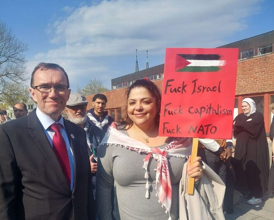 Norway’s Foreign Minister Espen Barth Eide, seemingly unaware of the placard held aloft. Her family was among the Palestinian ‘migrant families’ who arrived after the First Gulf War, when Norway opened its borders to Muslim migrants with little screening. Norway’s Foreign Minister Espen Barth Eide, seemingly unaware of the placard held aloft. Her family was among the Palestinian ‘migrant families’ who arrived after the First Gulf War, when Norway opened its borders to Muslim migrants with little screening.