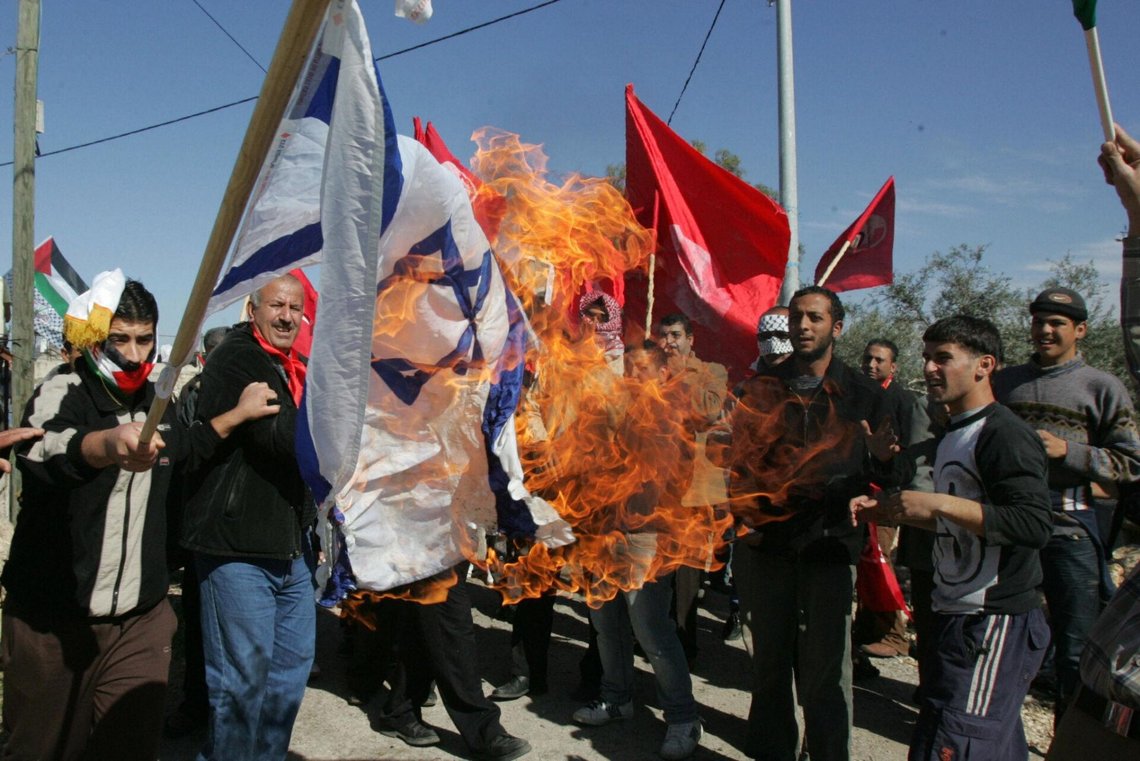 An Israeli flag is burned outside the Israeli embassy in Cairo during a pro-Palestinian demonstration on 15 May 2011. Photo: Gigi Ibrahim / Wikimedia Commons, CC BY 2.0. An Israeli flag is burned outside the Israeli embassy in Cairo during a pro-Palestinian demonstration on 15 May 2011. Photo: Gigi Ibrahim / Wikimedia Commons, CC BY 2.0.
