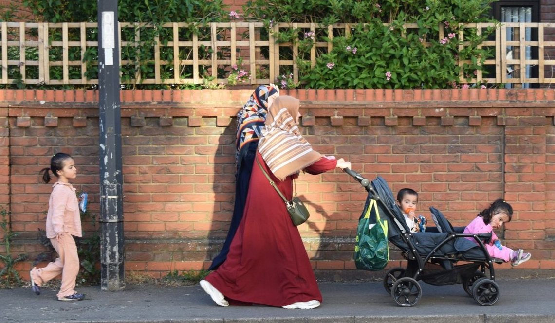Maidenhead, United Kingdom, 1 May 2026: Muslim mothers walking along the pavement with their children. Photo: Jun Huang / Shutterstock. Maidenhead, United Kingdom, 1 May 2026: Muslim mothers walking along the pavement with their children. Photo: Jun Huang / Shutterstock.
