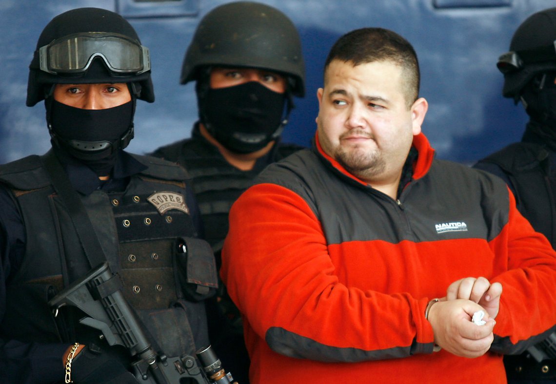 Mexican Federal Police present Teodoro Garcia Simental, known as "El Teo" or "Tres Letras" a member of Tijuana cartels to the media in Mexico City January 12, 2010. Mexican police on Tuesday captured Garcia Simental, a drug kingpin known for having the corpses of tortured rivals dissolved in acid and blamed for much of a surge in violence in the northern border city of Tijuana, police said. REUTERS/Eliana Aponte (MEXICO - Tags: CRIME LAW SOCIETY) Mexican Federal Police present Teodoro Garcia Simental, known as "El Teo" or "Tres Letras" a member of Tijuana cartels to the media in Mexico City January 12, 2010. Mexican police on Tuesday captured Garcia Simental, a drug kingpin known for having the corpses of tortured rivals dissolved in acid and blamed for much of a surge in violence in the northern border city of Tijuana, police said. REUTERS/Eliana Aponte (MEXICO - Tags: CRIME LAW SOCIETY)