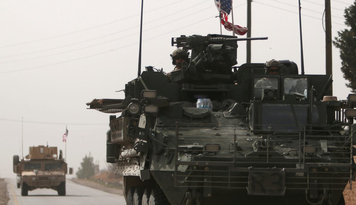 FILE PHOTO: American army vehicles drive north of Manbij city, in Aleppo Governorate, Syria March 9, 2017. To match Analysis MIDEAST-CRISIS/SYRIA-WAR REUTERS/Rodi Said/File Photo FILE PHOTO: American army vehicles drive north of Manbij city, in Aleppo Governorate, Syria March 9, 2017. To match Analysis MIDEAST-CRISIS/SYRIA-WAR REUTERS/Rodi Said/File Photo