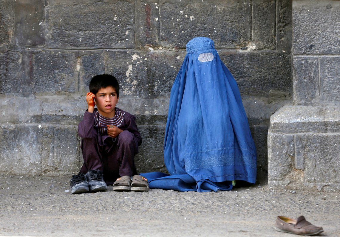 An Afghan woman and her son beg at a mosque on the first day of Eid al-Fitr, which marks the end of the holy month of Ramadan, in Kabul, Afghanistan June 25, 2017. REUTERS/Omar Sobhani An Afghan woman and her son beg at a mosque on the first day of Eid al-Fitr, which marks the end of the holy month of Ramadan, in Kabul, Afghanistan June 25, 2017. REUTERS/Omar Sobhani