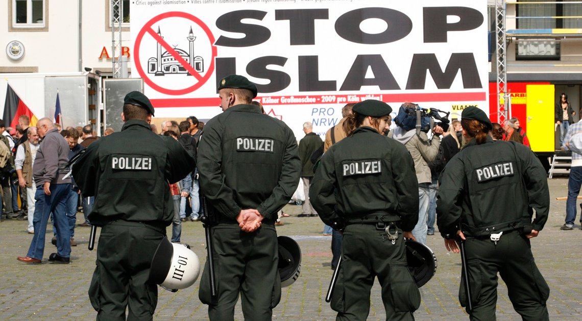 Police officers line up in front of a banner reading 'stop islam' during a demonstration in Cologne September 20, 2008. German police cancelled an anti-Islamic congress planned for Saturday in Cologne after leftist opponents of the rally clashed repeatedly with its right-wing backers. The group Pro-Cologne called the rally to oppose a decision by local authorities in Cologne, Germany's fourth largest city and famous worldwide for its gothic Cathedral, to allow the construction of a mosque with a high dome an minarets.
REUTERS/Ina Fassbender (GERMANY) Police officers line up in front of a banner reading 'stop islam' during a demonstration in Cologne September 20, 2008. German police cancelled an anti-Islamic congress planned for Saturday in Cologne after leftist opponents of the rally clashed repeatedly with its right-wing backers. The group Pro-Cologne called the rally to oppose a decision by local authorities in Cologne, Germany's fourth largest city and famous worldwide for its gothic Cathedral, to allow the construction of a mosque with a high dome an minarets.
REUTERS/Ina Fassbender (GERMANY)