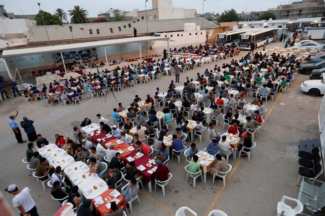 Muslims migrants wait to have their Iftar meal during the holy fasting month of Ramadan, at a detention centre in Tripoli, Libya May 30, 2018. Picture taken May 30, 2018. REUTERS/Ismail Zitouny Muslims migrants wait to have their Iftar meal during the holy fasting month of Ramadan, at a detention centre in Tripoli, Libya May 30, 2018. Picture taken May 30, 2018. REUTERS/Ismail Zitouny