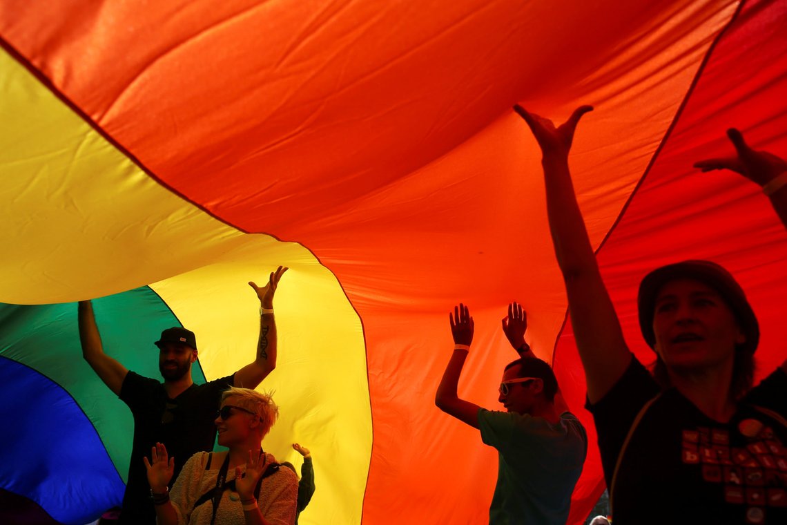 Participants dance under a rainbow flag during an annual LGBT (Lesbian, Gay, Bisexual and Transgender) pride parade in Belgrade, Serbia September 18, 2016. REUTERS/Marko Djurica Participants dance under a rainbow flag during an annual LGBT (Lesbian, Gay, Bisexual and Transgender) pride parade in Belgrade, Serbia September 18, 2016. REUTERS/Marko Djurica