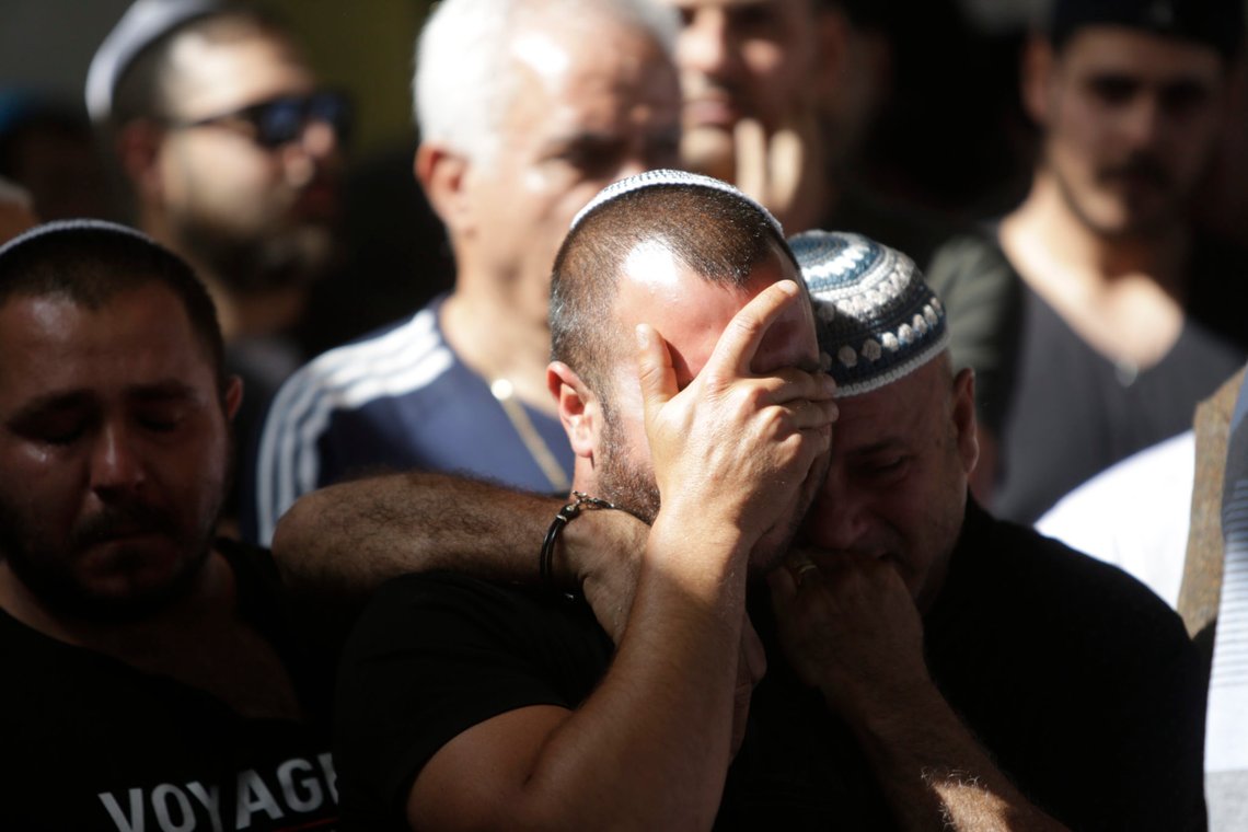People cry during the funeral of Moshe Agadi in the city of Ashkelon, Israel, Sunday.May 5, 2019. Agadi was killed outside his home in Ashkelon by a rocket fired from Gaza Strip. (AP Photo/Sebastian Scheiner) People cry during the funeral of Moshe Agadi in the city of Ashkelon, Israel, Sunday.May 5, 2019. Agadi was killed outside his home in Ashkelon by a rocket fired from Gaza Strip. (AP Photo/Sebastian Scheiner)