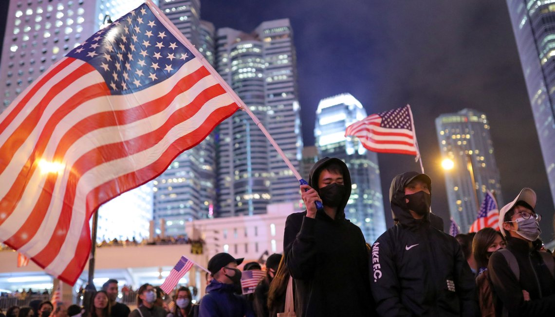A protestor holds a U.S. flag while he attends a gathering at the Edinburgh place in Hong Kong, China, November 28, 2019. REUTERS/Marko Djurica A protestor holds a U.S. flag while he attends a gathering at the Edinburgh place in Hong Kong, China, November 28, 2019. REUTERS/Marko Djurica