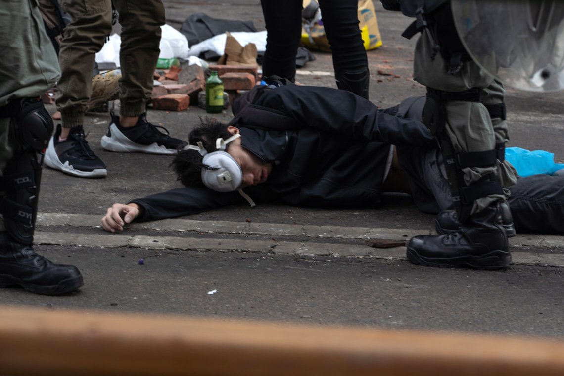 epa08005076 Riot police detain a pro-democracy protester during clashes outside the Hong Kong Polytechnic University (PolyU), in Hong Kong, China, 18 November 2019. Hong Kong is in its sixth month of mass protests, which were originally triggered by a now withdrawn extradition bill and have since turned into a wider pro-democracy movement. EPA/BING GUAN epa08005076 Riot police detain a pro-democracy protester during clashes outside the Hong Kong Polytechnic University (PolyU), in Hong Kong, China, 18 November 2019. Hong Kong is in its sixth month of mass protests, which were originally triggered by a now withdrawn extradition bill and have since turned into a wider pro-democracy movement. EPA/BING GUAN