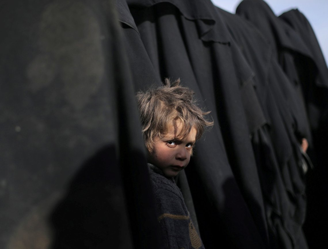 A boy waits with his mother as they queue with others for humanitarian and medical help after leaving Baghouz, the last stronghold of the Islamic State caliphate, in Deir Al Zor, Syria, March 5, 2019. REUTERS/Rodi Said A boy waits with his mother as they queue with others for humanitarian and medical help after leaving Baghouz, the last stronghold of the Islamic State caliphate, in Deir Al Zor, Syria, March 5, 2019. REUTERS/Rodi Said