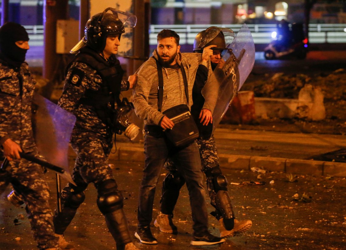 Riot police restrain a protestor during a protest against a ruling elite accused of steering Lebanon towards economic crisis in Beirut, Lebanon January 18, 2020. REUTERS/Mohamed Azakir Riot police restrain a protestor during a protest against a ruling elite accused of steering Lebanon towards economic crisis in Beirut, Lebanon January 18, 2020. REUTERS/Mohamed Azakir