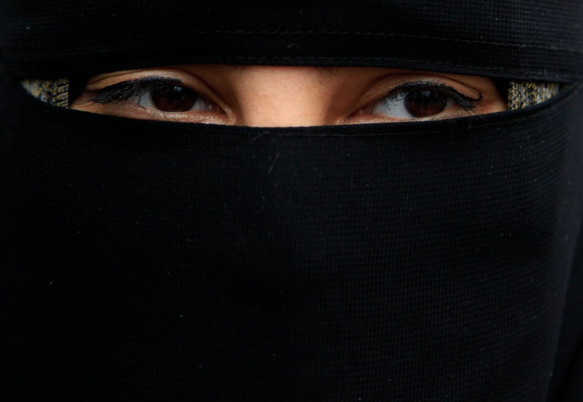 A demonstrator wears a niqab during a protest outside the French embassy in London April 11, 2011. France's ban on full face veils, a first in Europe, went into force today, exposing anyone who wears the Muslim niqab or burqa in public to fines of 150 euros ($216) and lessons in French citizenship. REUTERS/Stefan Wermuth (BRITAIN - Tags: POLITICS RELIGION CIVIL UNREST HEADSHOT) A demonstrator wears a niqab during a protest outside the French embassy in London April 11, 2011. France's ban on full face veils, a first in Europe, went into force today, exposing anyone who wears the Muslim niqab or burqa in public to fines of 150 euros ($216) and lessons in French citizenship. REUTERS/Stefan Wermuth (BRITAIN - Tags: POLITICS RELIGION CIVIL UNREST HEADSHOT)