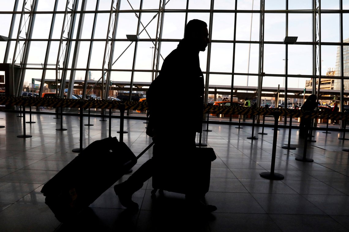 FILE PHOTO: International travelers arrive at John F. Kennedy international airport in New York City, U.S., February 4, 2017. The United States is screening visitors from Wuhan, China at JFK and at airports in Los Angeles and San Francisco for people who may have symptoms of a new virus. REUTERS/Brendan McDermid/File Photo FILE PHOTO: International travelers arrive at John F. Kennedy international airport in New York City, U.S., February 4, 2017. The United States is screening visitors from Wuhan, China at JFK and at airports in Los Angeles and San Francisco for people who may have symptoms of a new virus. REUTERS/Brendan McDermid/File Photo