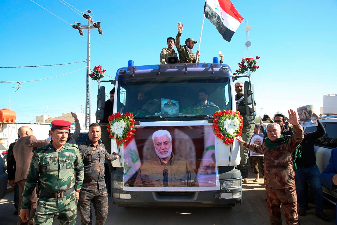 Mourners gather during a funeral procession for Abu Mahdi al-Muhandis, in the poster, deputy commander of Iran-backed militias in Basra, Iraq, Tuesday, Jan. 7, 2020. Thousands of people gathered in Basra on Tuesday to bid farewell to Abu Mahdi al-Muhandis, a senior Iraqi militia commander who was killed in a US airstrike on Friday. (AP Photo) Mourners gather during a funeral procession for Abu Mahdi al-Muhandis, in the poster, deputy commander of Iran-backed militias in Basra, Iraq, Tuesday, Jan. 7, 2020. Thousands of people gathered in Basra on Tuesday to bid farewell to Abu Mahdi al-Muhandis, a senior Iraqi militia commander who was killed in a US airstrike on Friday. (AP Photo)