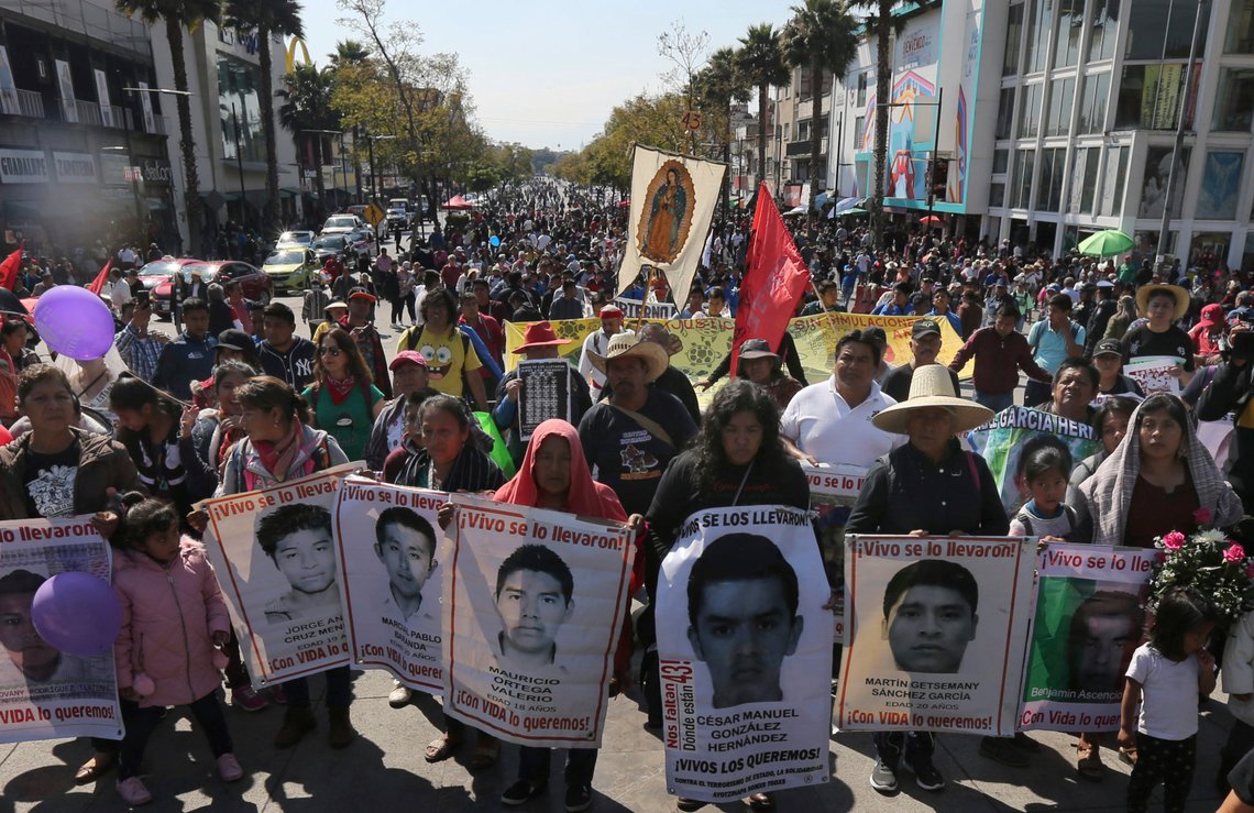 Mothers and relatives of the 43 missing students from the Isidro Burgos rural teachers college, with posters of their missing loved ones, walk to a Mass at the Basilica of Guadalupe in Mexico City, Thursday, Dec. 26, 2019. Family members continue to call for justice five years after the Ayotzinapa students were allegedly taken from buses by local police and turned over to a drug gang. (AP Photo/Marco Ugarte) Mothers and relatives of the 43 missing students from the Isidro Burgos rural teachers college, with posters of their missing loved ones, walk to a Mass at the Basilica of Guadalupe in Mexico City, Thursday, Dec. 26, 2019. Family members continue to call for justice five years after the Ayotzinapa students were allegedly taken from buses by local police and turned over to a drug gang. (AP Photo/Marco Ugarte)