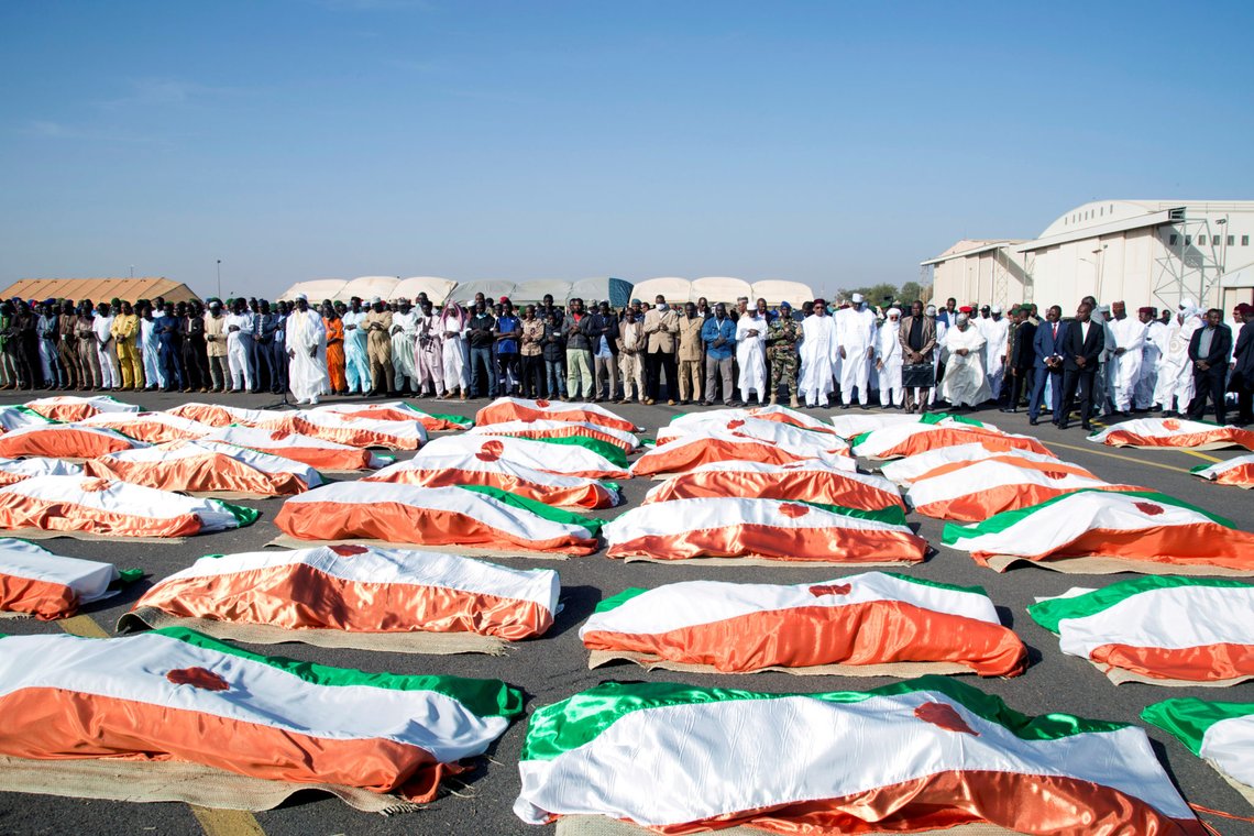 Families and officials pray in front of the flag-draped soldiers, killed during an attack on the army camp on the Niger- Mali border, during their burial ceremony at military airport in Niamey, Niger, December 13, 2019. REUTERS/ Tagaza Djibo TPX IMAGES OF THE DAY Families and officials pray in front of the flag-draped soldiers, killed during an attack on the army camp on the Niger- Mali border, during their burial ceremony at military airport in Niamey, Niger, December 13, 2019. REUTERS/ Tagaza Djibo TPX IMAGES OF THE DAY