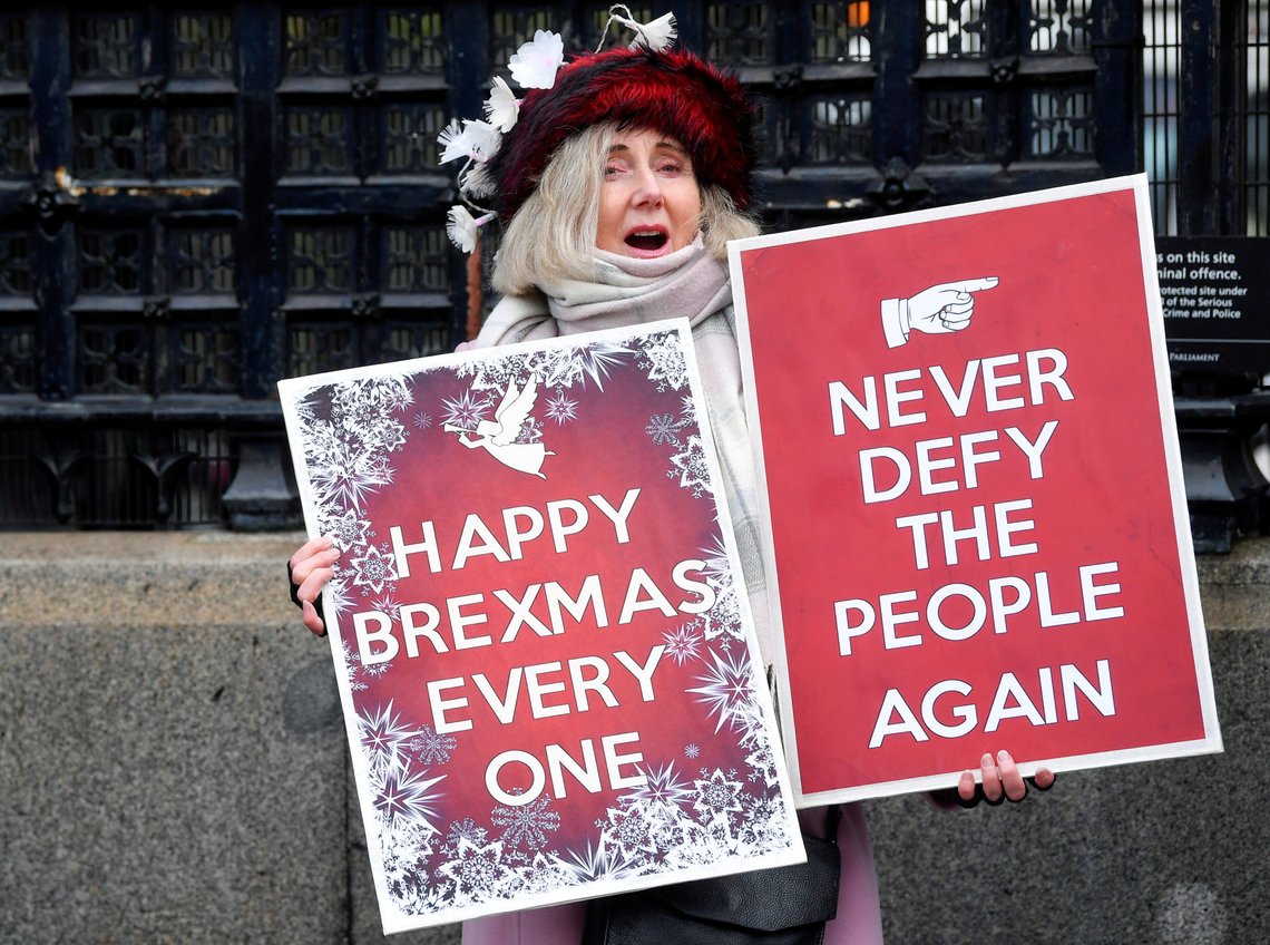 A pro-Brexit demonstrator holds a sign outside the Houses of Parliament in London, Britain, December 17, 2019. REUTERS/Toby Melville REFILE - CORRECTING LOCATION A pro-Brexit demonstrator holds a sign outside the Houses of Parliament in London, Britain, December 17, 2019. REUTERS/Toby Melville REFILE - CORRECTING LOCATION