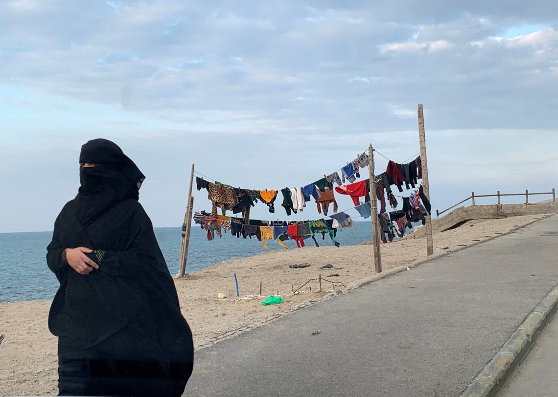 A Palestinian woman walks as laundry hangs on a rope along the beach at Shati refugee camp in Gaza city, January 12, 2020. REUTERS/Mohammed Salem A Palestinian woman walks as laundry hangs on a rope along the beach at Shati refugee camp in Gaza city, January 12, 2020. REUTERS/Mohammed Salem