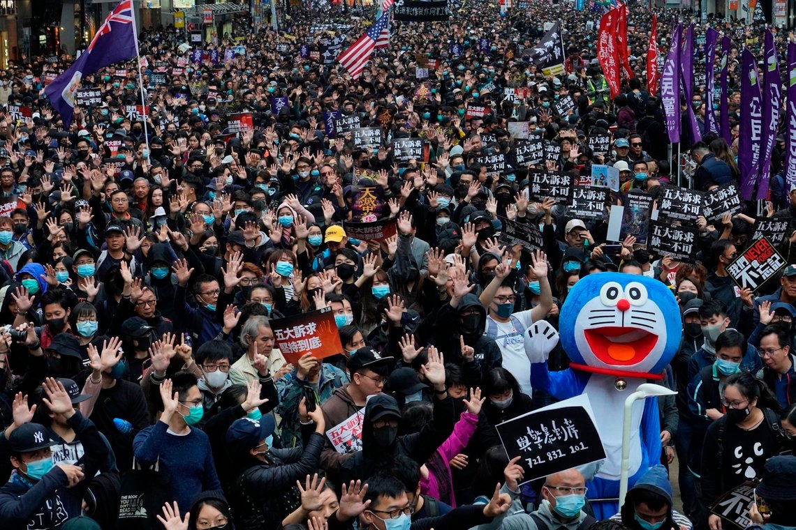 Hong Kong people participate in their annual pro-democracy march on New Year's Day to insist their five demands be matched by the government in Hong Kong, Wednesday, Jan. 1, 2020. The five demands include democratic elections for Hong Kong's leader and legislature and a demand for a probe of police behavior during the six months of continuous protests. (AP Photo/Vincent Yu) Hong Kong people participate in their annual pro-democracy march on New Year's Day to insist their five demands be matched by the government in Hong Kong, Wednesday, Jan. 1, 2020. The five demands include democratic elections for Hong Kong's leader and legislature and a demand for a probe of police behavior during the six months of continuous protests. (AP Photo/Vincent Yu)