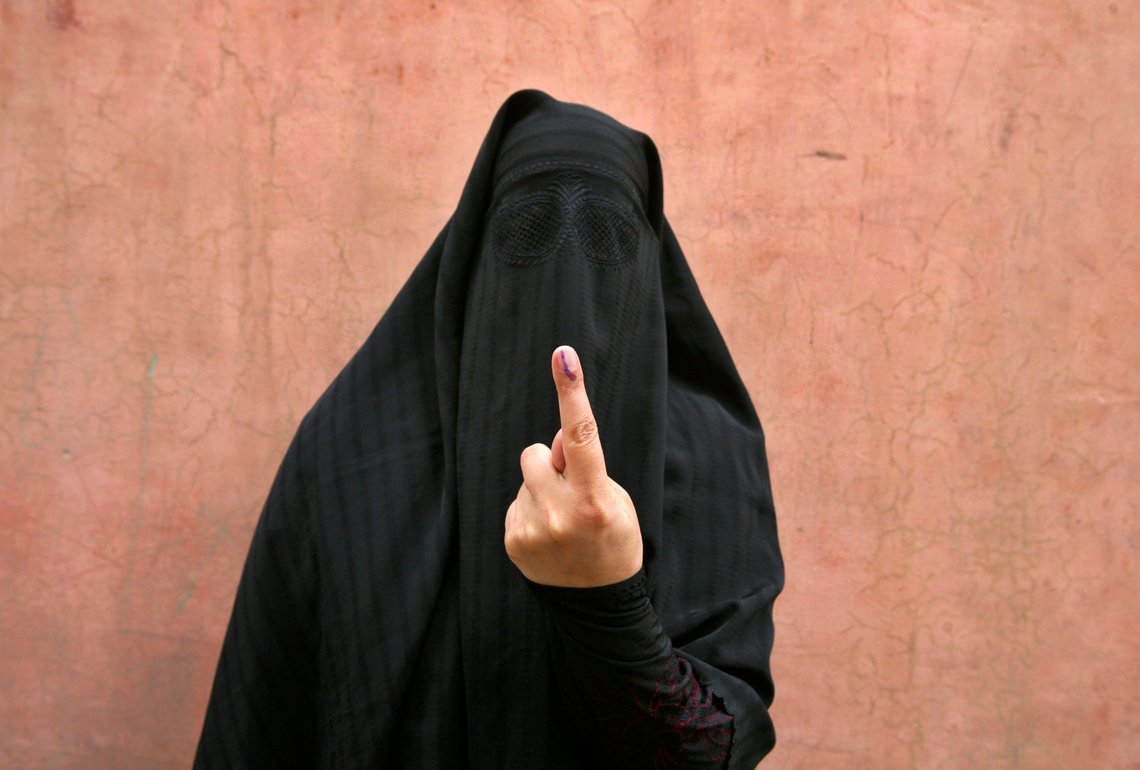 A veiled Muslim woman shows her ink-marked finger after voting outside a polling station in Doda district, north of Jammu, April 17, 2014. Around 815 million people have registered to vote in the world's biggest election - a number exceeding the population of Europe and a world record - and results of the mammoth exercise, which concludes on May 12, are due on May 16. REUTERS/Mukesh Gupta (INDIAN-ADMINISTERED KASHMIR - Tags: POLITICS ELECTIONS) A veiled Muslim woman shows her ink-marked finger after voting outside a polling station in Doda district, north of Jammu, April 17, 2014. Around 815 million people have registered to vote in the world's biggest election - a number exceeding the population of Europe and a world record - and results of the mammoth exercise, which concludes on May 12, are due on May 16. REUTERS/Mukesh Gupta (INDIAN-ADMINISTERED KASHMIR - Tags: POLITICS ELECTIONS)