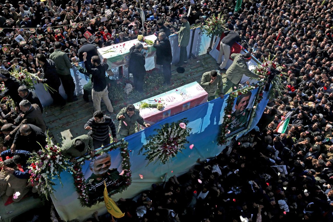 Iranian mourners gather around a vehicle carrying the coffin of slain top general Qasem Soleimani during the final stage of funeral processions, in his hometown Kerman on January 7, 2020. - Soleimani was killed outside Baghdad airport Friday in a drone strike ordered by US President Donald Trump, ratcheting up tensions with arch-enemy Iran which has vowed "severe revenge". The assassination of the 62-year-old heightened international concern about a new war in the volatile, oil-rich Middle East and rattled financial markets. (Photo by ATTA KENARE / AFP) Iranian mourners gather around a vehicle carrying the coffin of slain top general Qasem Soleimani during the final stage of funeral processions, in his hometown Kerman on January 7, 2020. - Soleimani was killed outside Baghdad airport Friday in a drone strike ordered by US President Donald Trump, ratcheting up tensions with arch-enemy Iran which has vowed "severe revenge". The assassination of the 62-year-old heightened international concern about a new war in the volatile, oil-rich Middle East and rattled financial markets. (Photo by ATTA KENARE / AFP)